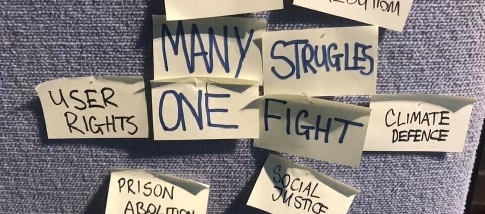 Post-it notes reading 'many struggles one fight', with notes around it reading 'users rights', 'prison abolition' and 'climate defence'.
