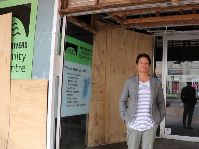 Nicole Jenkins outside the boarded-up and flood damaged Northern Rivers Community Legal Centre office.