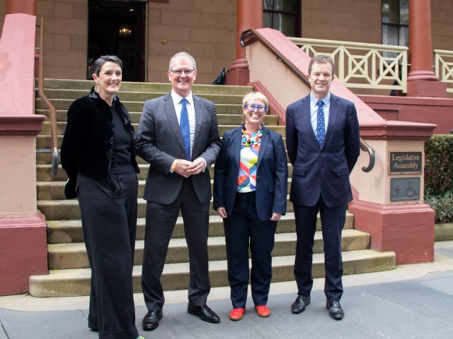 Four people standing outside NSW Parliament House: Katrina Ironside (Executive Director, Community Legal Centres NSW), Michael Daley (Shadow Attorney General), Sarah Marland (Policy and Advocacy Manager, Community Legal Centres NSW), and The Hon. Mark Speakman (Attorney General).