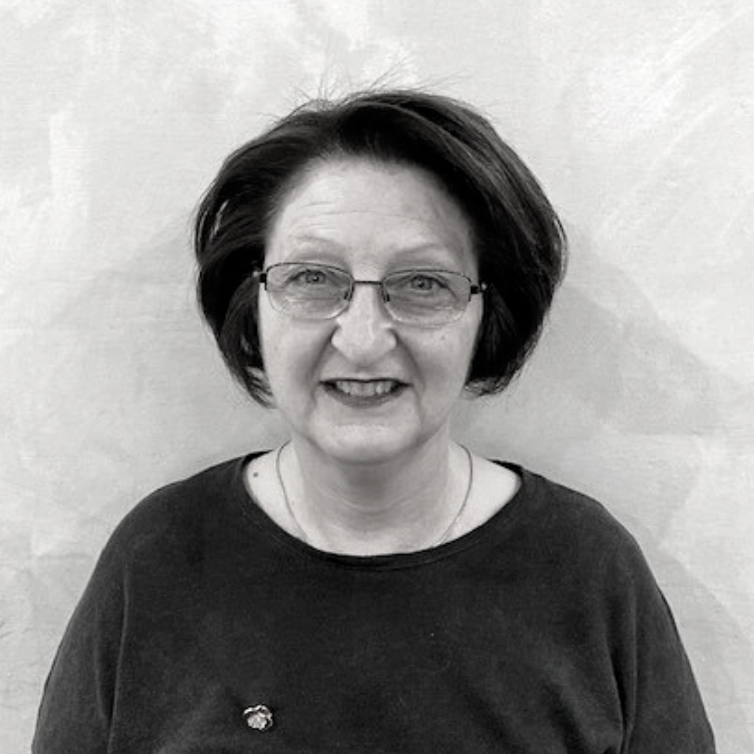 Headshot of a woman with short dark hair and glasses.