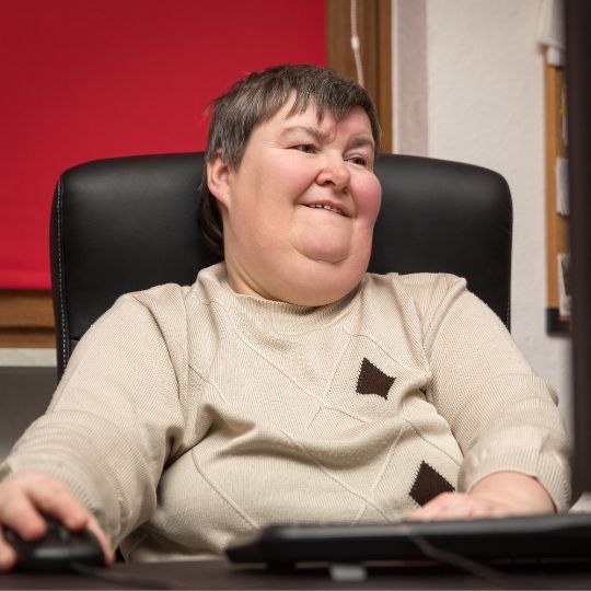 A woman with short hair smiling.