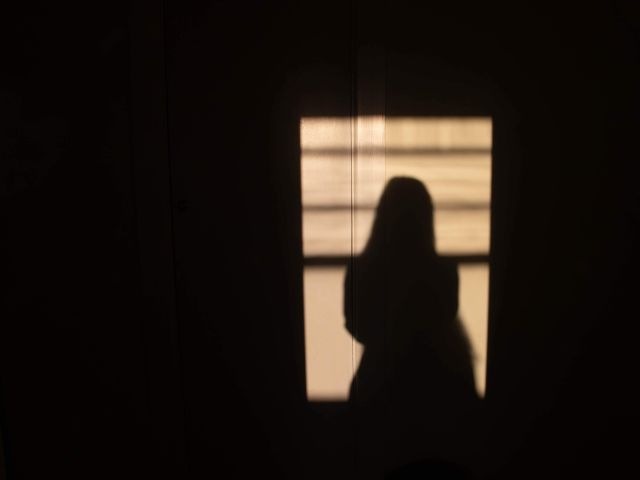 Silhouette of a woman on a wall.