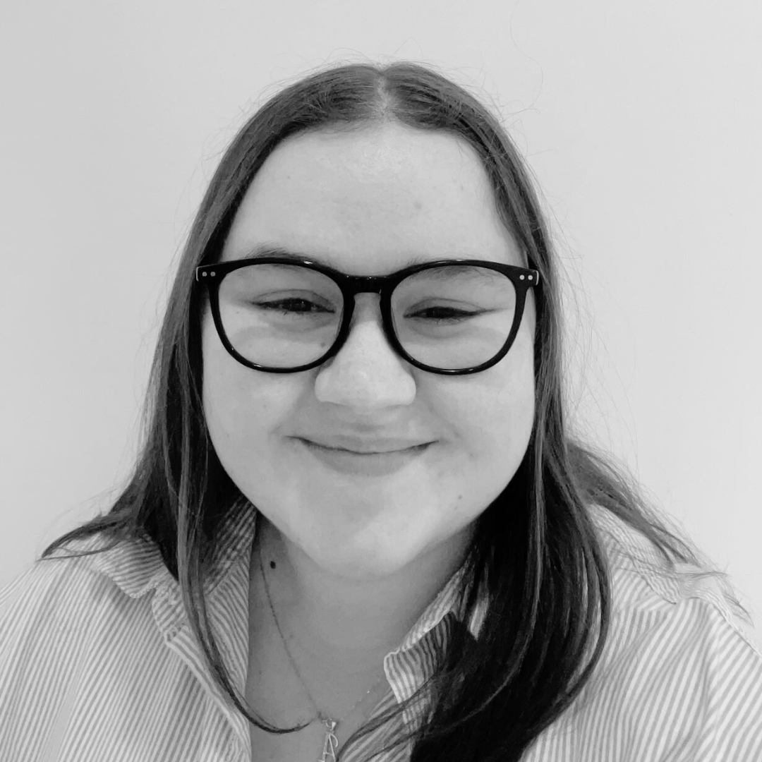 Headshot of Aimee Lawson smiling, with glasses and long hair.