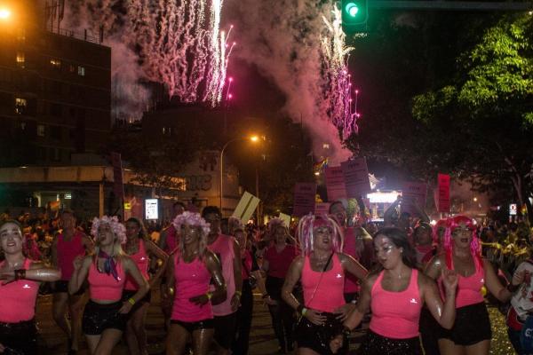 Community legal centre staff march in a Mardi Gras parade.