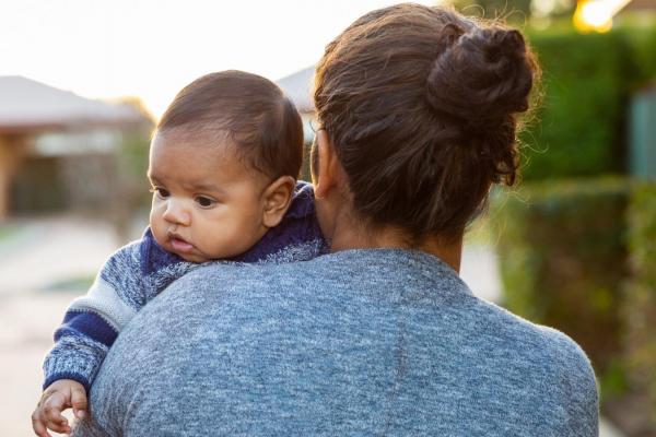 Woman walking with baby.