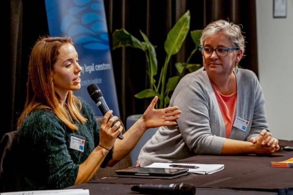 Three people on a conference panel.