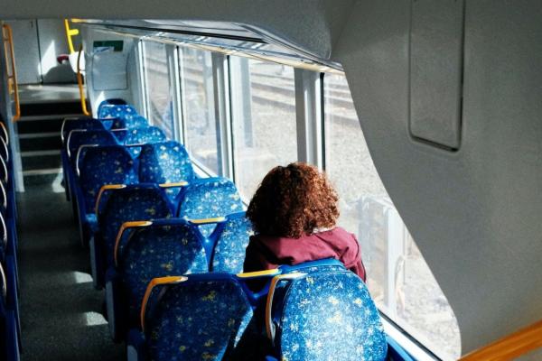 Person sitting on a Sydney train.