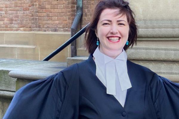 Portrait of Joanna Knight who is smiling and wearing a black robe.